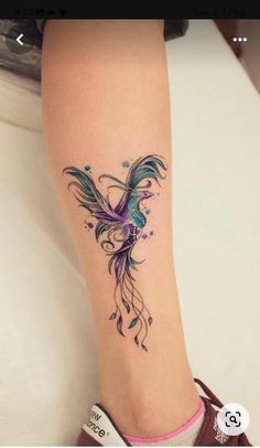 a woman's foot with a tattoo design on the side of her leg,