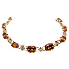 Semi-rigid choker necklace made in yellow gold with large oval-cut quartz (Citrines) alternating with intertwined links centered by two cabochon-cut rubies and two brilliant-cut diamonds. The necklace can be divided into two bracelets and a pendant. Approx. weight of stones: Quartz: 115,00 cts Diamonds: 1,60 cts, colour H, clarity VVS, Rubies: 4,00 cts 1950s Luxury Orange Necklace With Natural Stones, Luxury Vintage Antique Gold Necklace, Oval Citrine Jewelry For Formal Occasions, Formal Citrine Necklace With Oval Shape, Oval Citrine Necklace For Formal Occasions, Formal Oval Amber Necklace, Drink Outfit, Orange Quartz, Hand Jewelry Rings