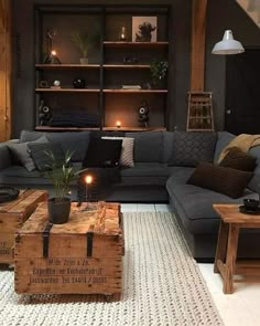 a living room filled with furniture and a wooden box on top of a rug next to a coffee table