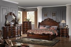 a bedroom scene with focus on the bed, dresser and mirror in the room's center