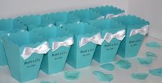 small blue paper bags with white bows on them