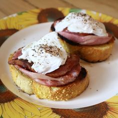 two pastries with bacon and sour cream on top are sitting on a floral plate