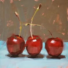 three red apples sitting side by side on a blue surface with the words carol marine above them