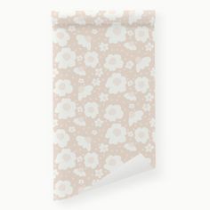 a flowered wallpaper with white flowers on a pink background and a corner cut in half