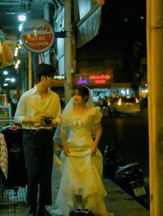 a man and woman standing on the sidewalk