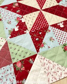 a red and green patchwork quilt with flowers on it