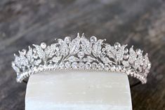 a tiara is sitting on top of a piece of wood