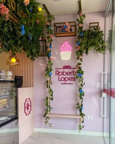 the inside of a bakery with flowers growing on the wall