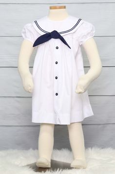 "She will look amazing in her nautical clothing for a nautical birthday in a sailor dress by Zuli Kids. Toddler sailor dress is shown in white with navy soutache trim on sailor collar. Also available in navy with white soutache trim. *Zuli Kids Premium Quality *Nautical Collar *Machine Wash Gentle *Button-Back Closures *Poly Cotton Fabirc *Puffed Sleeves *Short or Long Sleeves *Available in Sz 12 Mo - Sz 5 *Special Classic Garment to Commemorate the Special Day *Made in USA WHATS INCLUDED One sa Summer Short Sleeve School Uniform Dress, Summer School Uniform Dress With Short Sleeves, Preppy Navy Cotton Dress, Preppy Fitted White Dress, White Sailor Dresses For Spring, White Sailor Style Dress For Spring, Nautical Navy Cotton Dress, Navy Nautical Cotton Dress, Cute Navy School Dress