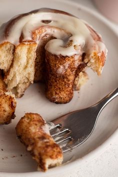 a plate that has some kind of pastry on it with a fork next to it