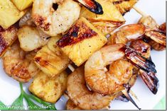 grilled shrimp and pineapple skewers on a white plate