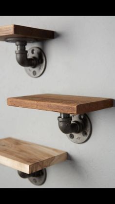 two wooden shelves with metal brackets on them