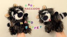 two stuffed animals are being held up by someone's hands with the words baby raccoon and hand puppet on them