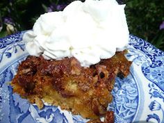 a blue and white plate topped with a slice of pie covered in whipped cream on top of it