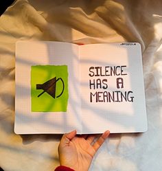 a hand holding an open book that says science has a meaning