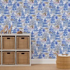 a blue and white wallpaper with many animals on it, next to some baskets