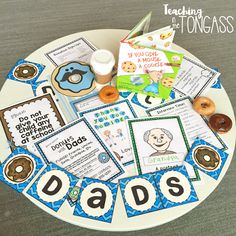 a plate with cards, doughnuts and other items for dad's day