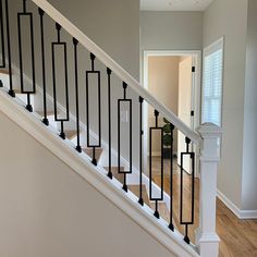 a white staircase with black handrails in a new home's entryway