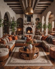 a living room filled with furniture and a fire place in the middle of the room