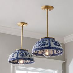 two blue and white lamps hanging from the ceiling