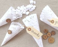 three paper cones with thank you written on them and some wooden buttons in the middle