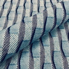 a blue and white checkered fabric with wavy lines