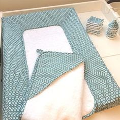 a blue and white blanket sitting on top of a table