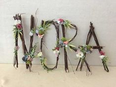 the letters are made out of twigs and flowers