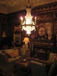 an ornate living room with chandelier and couches