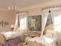 a bedroom with two beds and chandeliers in it