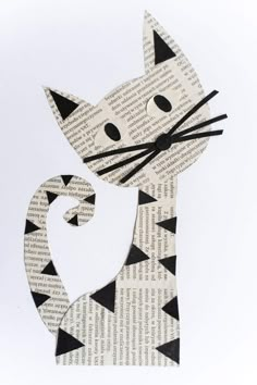 a paper cut out of a cat with black and white designs on it's face