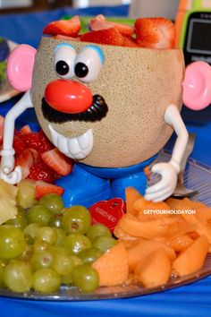 a close up of a plate of food with grapes and strawberries on the side