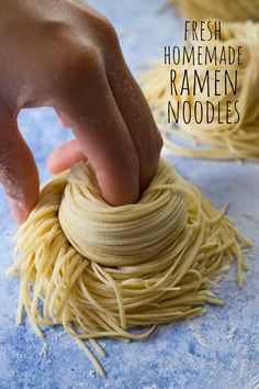 someone is making homemade ramen noodles on a blue surface with the words fresh homemade ramen noodles