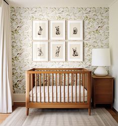 a baby's crib with four pictures on the wall