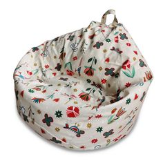 a white bean bag chair covered in colorful flowers and holly leaves on an off - white background