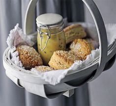 a basket filled with pastries next to a jar of mustard