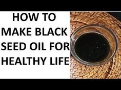 a bowl filled with black seed oil next to a basket