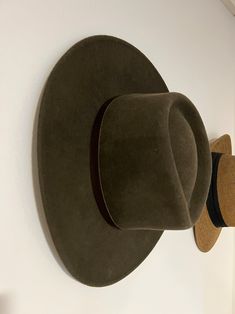 two hats are hanging on the wall