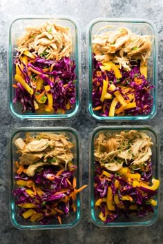 four glass containers filled with food on top of a gray countertop next to each other