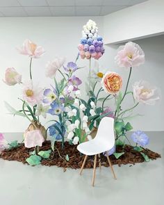 a white chair sitting on top of a pile of flowers