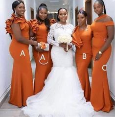 four women in orange dresses posing for the camera