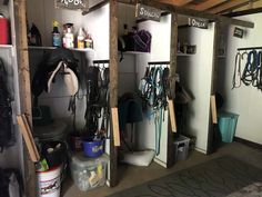 the inside of a horse stable with several stalls and tacks on it's walls