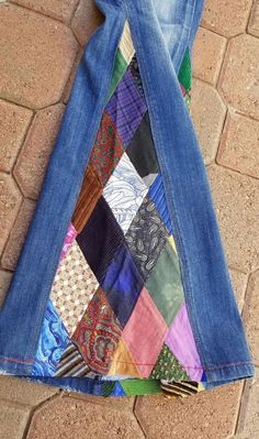 a pair of jeans that have been made out of different colored fabrics on the ground