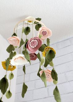 a mobile phone with flowers hanging from it's side and an instagram page below