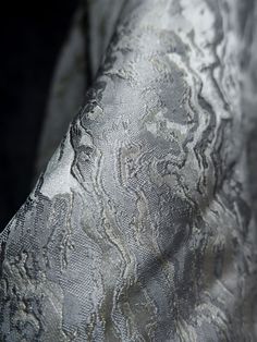 the fabric is shiny and silver in color