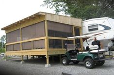 a golf cart is parked in front of a trailer with a camper attached to it