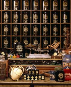 there are many items on the shelf in this room that is filled with bottles and jars