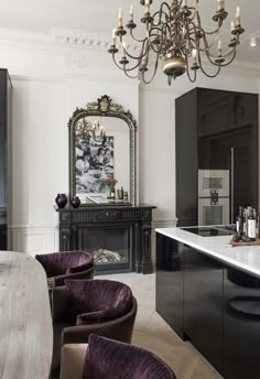 an elegant kitchen with black cabinets and purple chairs