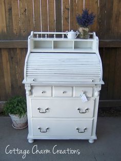 an old fashioned white dresser with drawers