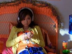 a woman sitting in a chair with headphones on